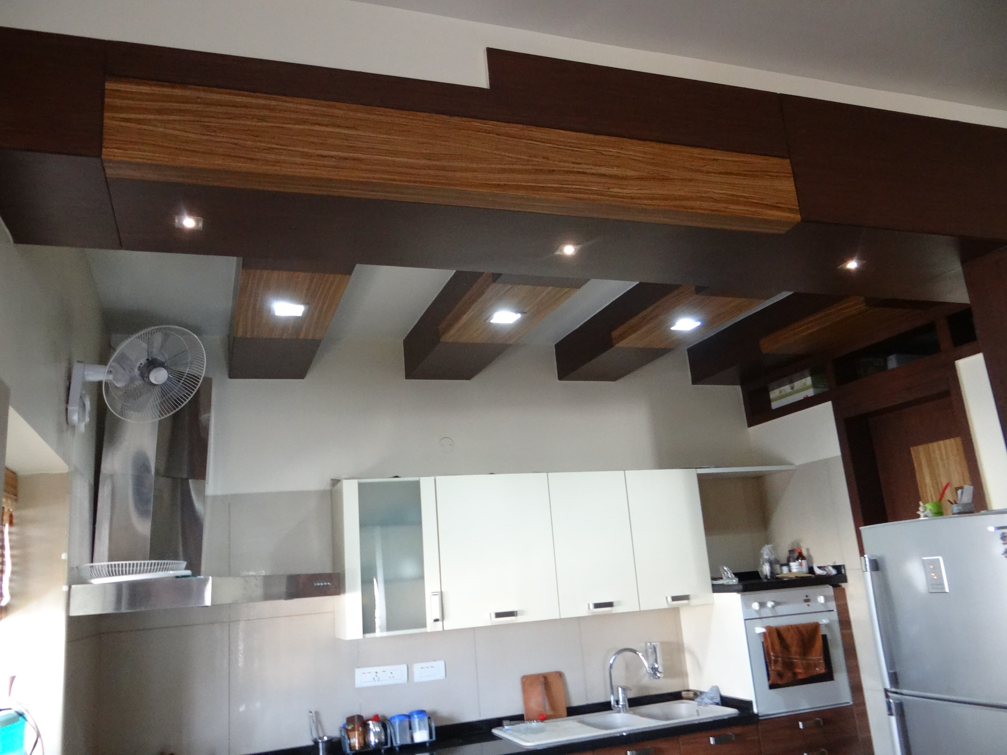 Modern Kitchen With Layered Wood Ceiling Detailing